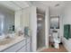 Clean bathroom featuring a walk-in shower, tiled floor, and a vanity with good storage at 2751 S Cranberry Blvd, North Port, FL 34286