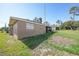 The exterior shows a lawn and the side of a home with white trimmed windows and stucco walls at 2751 S Cranberry Blvd, North Port, FL 34286