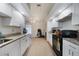 Modern kitchen with white cabinets, granite countertops, and sleek appliances offering efficient meal prep space at 2751 S Cranberry Blvd, North Port, FL 34286
