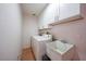 Practical laundry room featuring a washing machine, dryer, and sink for added convenience at 2751 S Cranberry Blvd, North Port, FL 34286