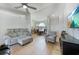 Bright living room with tile floors, a ceiling fan, and neutral decor, offering a welcoming space at 2751 S Cranberry Blvd, North Port, FL 34286