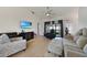 Spacious living room featuring tile floors, neutral decor, and ample space for comfortable seating at 2751 S Cranberry Blvd, North Port, FL 34286