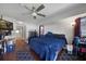 Cozy bedroom with wood-look floors, a ceiling fan, and ample space for relaxation and personal touches at 2751 S Cranberry Blvd, North Port, FL 34286