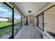 Relaxing screened patio with tile flooring and views of the backyard and shed at 2751 S Cranberry Blvd, North Port, FL 34286