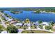 Aerial view of waterfront homes, a canal, and a picturesque neighborhood at 318 Spring Lake Nw Blvd, Port Charlotte, FL 33952