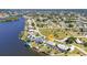 Aerial view featuring home, private pool, and waterfront property with boat lift at 318 Spring Lake Nw Blvd, Port Charlotte, FL 33952