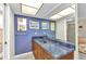 Bathroom with blue accent wall, custom countertops and mirror at 318 Spring Lake Nw Blvd, Port Charlotte, FL 33952