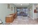 Bright dining area featuring tiled floors, neutral walls, a desk, and sliding glass doors to the patio at 318 Spring Lake Nw Blvd, Port Charlotte, FL 33952