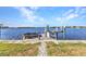 Private dock with boat lift and seating area on the waterfront at 318 Spring Lake Nw Blvd, Port Charlotte, FL 33952