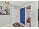 Inviting entryway with neutral walls, a blue door, decorative accents, and a stylish seashell themed rug at 318 Spring Lake Nw Blvd, Port Charlotte, FL 33952