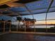 Screened in lanai offering views of waterfront and lighted tropical foliage at 318 Spring Lake Nw Blvd, Port Charlotte, FL 33952