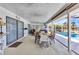 Spacious covered patio with seating, a ceiling fan, and views of the backyard and swimming pool at 318 Spring Lake Nw Blvd, Port Charlotte, FL 33952