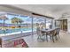 Inviting screened patio with waterfront pool and dining area, perfect for outdoor entertaining at 318 Spring Lake Nw Blvd, Port Charlotte, FL 33952