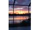 Screened-in lanai provides stunning sunset views over a serene body of water at 318 Spring Lake Nw Blvd, Port Charlotte, FL 33952