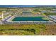 Expansive aerial view of a condo community with a central lake and lush landscaping near the water at 3310 Loveland Blvd # 1503, Punta Gorda, FL 33980