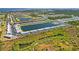 Aerial view of the community and large lake surrounded by lush greenery and residential buildings at 3310 Loveland Blvd # 1503, Punta Gorda, FL 33980