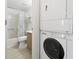 Bathroom and laundry room with stacked washer and dryer at 3310 Loveland Blvd # 1503, Punta Gorda, FL 33980
