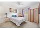 Bright bedroom with a ceiling fan, window, and decorative screen at 3310 Loveland Blvd # 1503, Punta Gorda, FL 33980