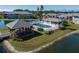 Beautiful community pool and recreation area featuring a gazebo, lake, and lush landscaping at 3310 Loveland Blvd # 1503, Punta Gorda, FL 33980