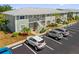 Exterior view of the community, showcasing well-maintained landscaping and ample parking at 3310 Loveland Blvd # 1503, Punta Gorda, FL 33980