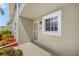 Close-up of the exterior entrance showcasing the unit number, window, and well-kept landscaping at 3310 Loveland Blvd # 1503, Punta Gorda, FL 33980