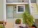 Close-up of the exterior entrance showcasing the unit number, window, and lush landscaping at 3310 Loveland Blvd # 1503, Punta Gorda, FL 33980