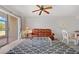 Living room with ceiling fan, brown leather couch, gray rug and sliding door access to the porch at 3310 Loveland Blvd # 1503, Punta Gorda, FL 33980