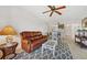 Open concept living room and kitchen with brown leather couch and bright lighting at 3310 Loveland Blvd # 1503, Punta Gorda, FL 33980