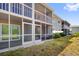 Close up of ground floor screened lanai with comfortable seating and sliding glass door at 3310 Loveland Blvd # 1503, Punta Gorda, FL 33980