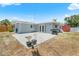 The backyard features a concrete patio with a grill and glass-paned french doors leading into the home at 3319 Shamrock Dr, Venice, FL 34293