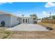 The backyard features a concrete patio with a grill and glass-paned french doors leading into the home at 3319 Shamrock Dr, Venice, FL 34293