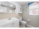 Clean, well-maintained bathroom featuring a sink, toilet, and mirrored cabinet at 3319 Shamrock Dr, Venice, FL 34293