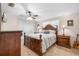 Comfortable bedroom featuring ceiling fan, closet, and a wooden bed frame with side tables at 3319 Shamrock Dr, Venice, FL 34293