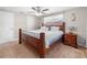 Cozy bedroom featuring a ceiling fan, a large window, and a wood bed frame at 3319 Shamrock Dr, Venice, FL 34293