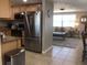 Modern kitchen featuring stainless steel appliances and granite countertops, open to a cozy living room at 3319 Shamrock Dr, Venice, FL 34293