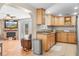 Well-lit kitchen featuring wooden cabinetry, granite countertops, and stainless steel appliances at 3319 Shamrock Dr, Venice, FL 34293