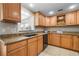 Functional kitchen featuring granite counters, stainless sink, and abundant natural light at 3319 Shamrock Dr, Venice, FL 34293
