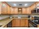 Well-maintained kitchen with ample cabinet space, granite countertops, and black appliances at 3319 Shamrock Dr, Venice, FL 34293