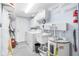 Neat laundry area with a sink, washer, dryer, storage cabinets, and a water heater at 3319 Shamrock Dr, Venice, FL 34293