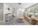Bright living room with a modern rug, comfortable seating, and neutral decor at 3319 Shamrock Dr, Venice, FL 34293