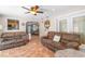 Open-concept living area with comfortable sofas, ceiling fan, and seamless access to the dining space at 3319 Shamrock Dr, Venice, FL 34293