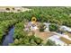 Stunning aerial view of a waterfront home with a private pool nestled among lush greenery at 3400 Allapatchee Dr, Punta Gorda, FL 33950