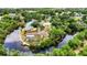 Picturesque aerial shot of a waterfront home with a screened-in pool, flourishing landscape, and a private dock at 3400 Allapatchee Dr, Punta Gorda, FL 33950