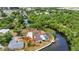 Scenic aerial view of waterfront home with lush greenery, canal access, and well-maintained landscaping at 3400 Allapatchee Dr, Punta Gorda, FL 33950