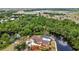 Stunning aerial view of waterfront home, canal access, lush landscaping, and private pool at 3400 Allapatchee Dr, Punta Gorda, FL 33950