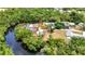 Beautiful aerial view of lush landscaping, river frontage, and sparkling pool at 3400 Allapatchee Dr, Punta Gorda, FL 33950