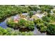 Unique aerial view shows a canal-front home featuring a screened lanai, trees, and a private dock at 3400 Allapatchee Dr, Punta Gorda, FL 33950