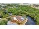 Picturesque aerial view of waterfront property, canal, lush greenery, and landscaped yard at 3400 Allapatchee Dr, Punta Gorda, FL 33950