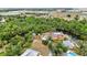 Waterfront home with screened pool, surrounded by lush greenery, canal access, and open yard at 3400 Allapatchee Dr, Punta Gorda, FL 33950