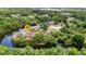Aerial view of a waterfront estate showcasing lush landscaping, a private pond, and serene natural surroundings at 3400 Allapatchee Dr, Punta Gorda, FL 33950